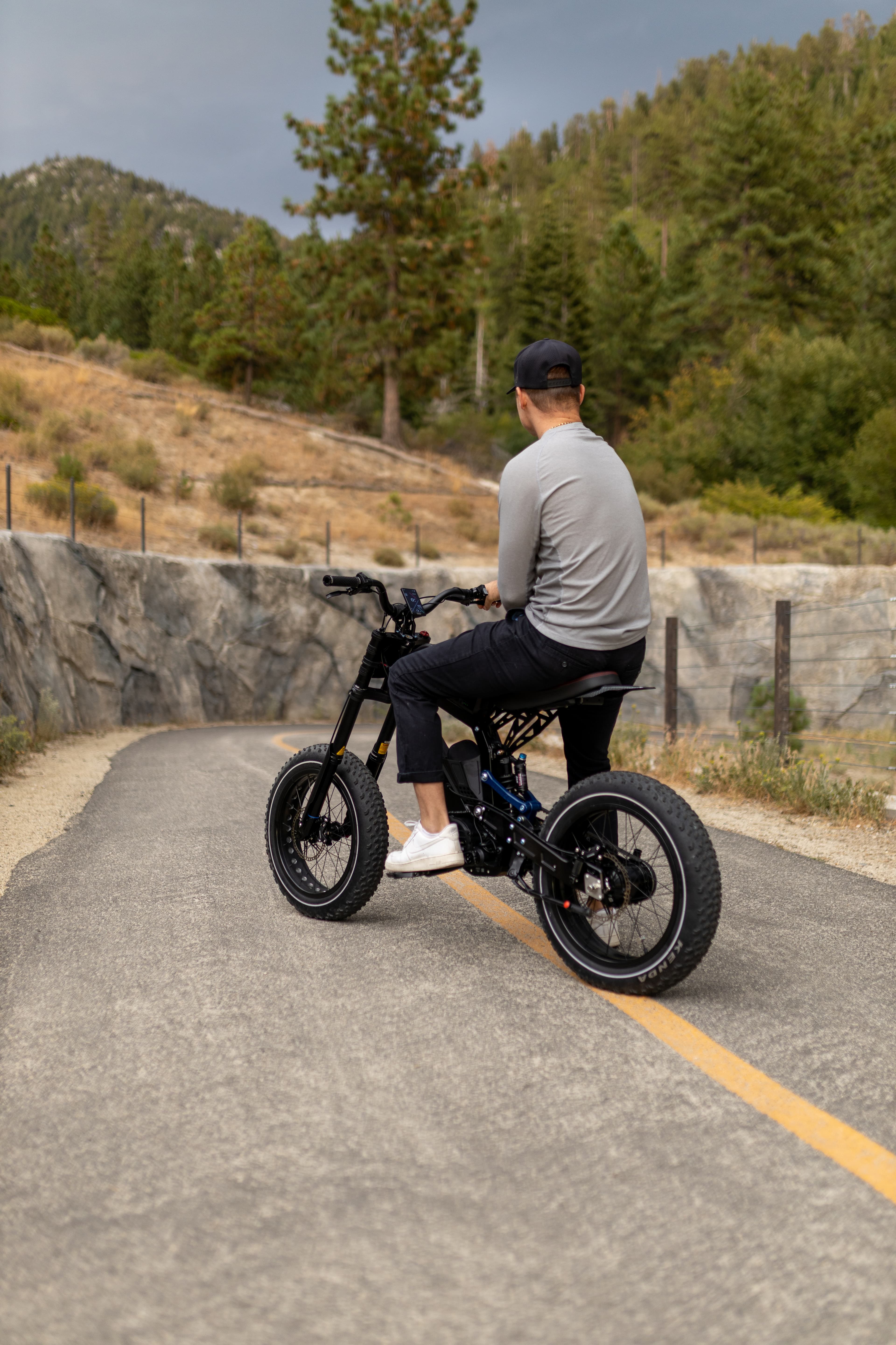 Rider on the Surfline cruising a Tahoe road with a helmet on